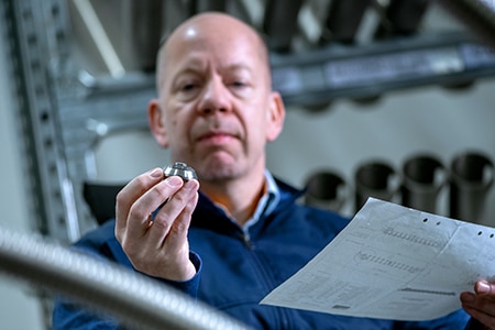 Silvent engineer inspecting an air nozzle in the workshop.